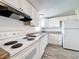 Well-lit kitchen features white cabinetry, appliances, and wood-look vinyl flooring at 5268 Rock Dove Loop, Lakeland, FL 33810