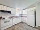 Well-maintained kitchen features white appliances, wood-look flooring, and ample counter space at 5268 Rock Dove Loop, Lakeland, FL 33810