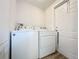 Bright laundry room with washer and dryer next to an exterior door at 5268 Rock Dove Loop, Lakeland, FL 33810