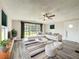Bright living room boasts a large window, ceiling fan, and comfortable seating at 5268 Rock Dove Loop, Lakeland, FL 33810