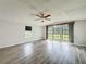 Inviting living room with large windows offering scenic views and stylish laminate flooring at 5268 Rock Dove Loop, Lakeland, FL 33810