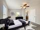 The primary bedroom includes plush bedding, natural light, and an en-suite bathroom at 5268 Rock Dove Loop, Lakeland, FL 33810