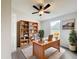 A cozy home office has a built-in bookcase, a wooden desk, and lots of natural light at 5268 Rock Dove Loop, Lakeland, FL 33810