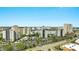 Scenic aerial view of multiple hotels, with palm trees, a lake, parking lots, and streets in the foreground at 6165 Carrier Dr # 1309, Orlando, FL 32819