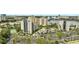 Aerial view of property featuring buildings, green space, parking lot and a lake in the background at 6165 Carrier Dr # 1309, Orlando, FL 32819