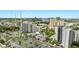 Scenic view of hotel and condo buildings, with a parking lot, pool, mature trees, and landscaped grounds at 6165 Carrier Dr # 1309, Orlando, FL 32819