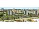 Aerial view of multiple hotels, a lake, parking lots, streets, mature trees, and landscaped grounds at 6165 Carrier Dr # 1309, Orlando, FL 32819