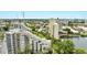 Scenic view of a multi-level condo complex, lake, pool, and manicured landscaping in the community at 6165 Carrier Dr # 1309, Orlando, FL 32819