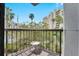 View of the building, pool, palm trees, and other tropical landscaping from the apartment balcony at 6165 Carrier Dr # 1309, Orlando, FL 32819