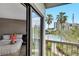 Sliding glass doors to the balcony with a view of the pool and surrounding tropical landscaping at 6165 Carrier Dr # 1309, Orlando, FL 32819