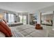 Bright bedroom featuring two beds, a balcony, a desk and a closet with mirrored doors at 6165 Carrier Dr # 1309, Orlando, FL 32819