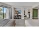 Bright bedroom featuring two beds, a desk and access to the kitchen through a mirrored closet door at 6165 Carrier Dr # 1309, Orlando, FL 32819