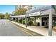 Inviting guest registration entrance with covered walkway, clean architecture, and tidy landscaping at 6165 Carrier Dr # 1309, Orlando, FL 32819