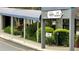 Well-maintained guest registration entrance featuring lush landscaping and a covered walkway at 6165 Carrier Dr # 1309, Orlando, FL 32819