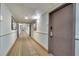 Hallway featuring carpeted floors, doors to units and wall mounted lights at 6165 Carrier Dr # 1309, Orlando, FL 32819
