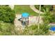 Aerial view of a playground with a small castle fort and swingset in a grassy landscaped area at 6165 Carrier Dr # 1309, Orlando, FL 32819