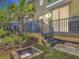 Outdoor living space featuring a spacious wooden deck, black metal railings, and a cozy fire pit at 67 Bella Oaks Dr, Port Orange, FL 32129
