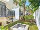 Backyard includes a stone fire pit with seating in a nicely landscaped area at 67 Bella Oaks Dr, Port Orange, FL 32129