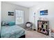 Bright bedroom with a window, a cozy chair, and a bookshelf filled with books and toys at 67 Bella Oaks Dr, Port Orange, FL 32129