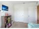 Well-lit bedroom with a decorative bookshelf, complemented by bright white walls at 67 Bella Oaks Dr, Port Orange, FL 32129