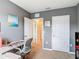 Neutral-toned bedroom featuring a dedicated workspace and ample closet space at 67 Bella Oaks Dr, Port Orange, FL 32129