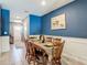 Dining room with blue accent wall, tile flooring, and a view of the living room at 67 Bella Oaks Dr, Port Orange, FL 32129