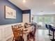 Dining room featuring wood table and chairs with blue accent wall and tile floors at 67 Bella Oaks Dr, Port Orange, FL 32129