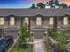 Charming townhome featuring a private garage, covered entry, and manicured front lawn landscaping at 67 Bella Oaks Dr, Port Orange, FL 32129