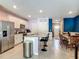 Open kitchen with stainless steel appliances, granite counters, breakfast bar and stainless steel refrigerator at 67 Bella Oaks Dr, Port Orange, FL 32129