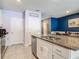 Spacious kitchen with white cabinets, stainless steel appliances and a large granite island at 67 Bella Oaks Dr, Port Orange, FL 32129