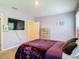 Relaxing bedroom featuring modern decor, a wall-mounted television, and an exit doorway at 67 Bella Oaks Dr, Port Orange, FL 32129