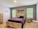 Cozy bedroom with a platform bed, two windows, and modern decor for relaxation and style at 67 Bella Oaks Dr, Port Orange, FL 32129