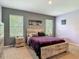 Cozy bedroom with a platform bed, two windows, and modern decor for relaxation and style at 67 Bella Oaks Dr, Port Orange, FL 32129