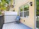 Inviting patio with a comfortable chair and views of tropical landscaping at 67 Bella Oaks Dr, Port Orange, FL 32129