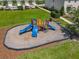 Community playground featuring colorful slides and climbing structures on a mulch surface at 67 Bella Oaks Dr, Port Orange, FL 32129