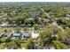 A high angle aerial view of the property nestled in a lush, green, tree-lined neighborhood at 1616 Huntington St, Lakeland, FL 33801