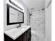 Modern bathroom with marble-tiled shower, sleek vanity, and contemporary fixtures at 1616 Huntington St, Lakeland, FL 33801