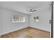 Bright bedroom with wood-look floors, ceiling fan, and large windows at 1616 Huntington St, Lakeland, FL 33801