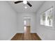 A sunlit bedroom features wood floors and a ceiling fan at 1616 Huntington St, Lakeland, FL 33801