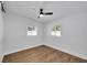 Bedroom featuring neutral walls, wood-look flooring, ceiling fan, and large windows at 1616 Huntington St, Lakeland, FL 33801