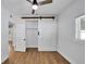 Bedroom showcasing wood-look floors, ceiling fan, and sliding closet doors at 1616 Huntington St, Lakeland, FL 33801