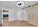 Comfortable bedroom with barn door closet, and doorway to hall and living space at 1616 Huntington St, Lakeland, FL 33801
