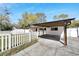 Charming single story home featuring covered parking, lawn, and white picket fence at 1616 Huntington St, Lakeland, FL 33801
