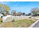 Charming single story home with an inviting walkway, white picket fence, and lush landscaping at 1616 Huntington St, Lakeland, FL 33801