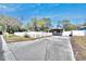 Charming single story home featuring a spacious driveway, lawn, and white picket fence at 1616 Huntington St, Lakeland, FL 33801
