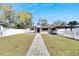 Charming home with an inviting walkway and white picket fence at 1616 Huntington St, Lakeland, FL 33801