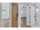 Hallway with a view into bedroom and bathroom, showcasing wood flooring at 1616 Huntington St, Lakeland, FL 33801