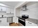 Well-equipped kitchen showcasing white cabinets, granite countertops, and stainless steel appliances at 1616 Huntington St, Lakeland, FL 33801