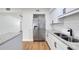 Kitchen displaying stainless steel refrigerator, granite countertops, double sink, and white subway tile backsplash at 1616 Huntington St, Lakeland, FL 33801