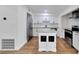 Bright kitchen featuring white cabinetry, stainless steel appliances, a center island, and wood flooring at 1616 Huntington St, Lakeland, FL 33801